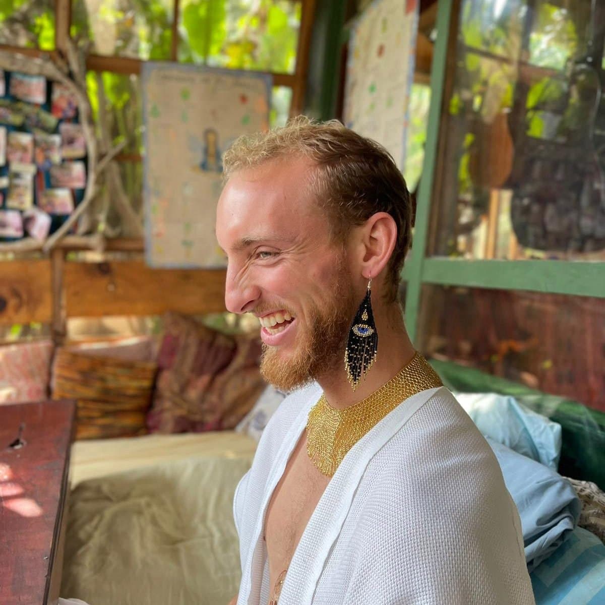 Riley, a HeartSong Mastery student, laughing on a jungle porch