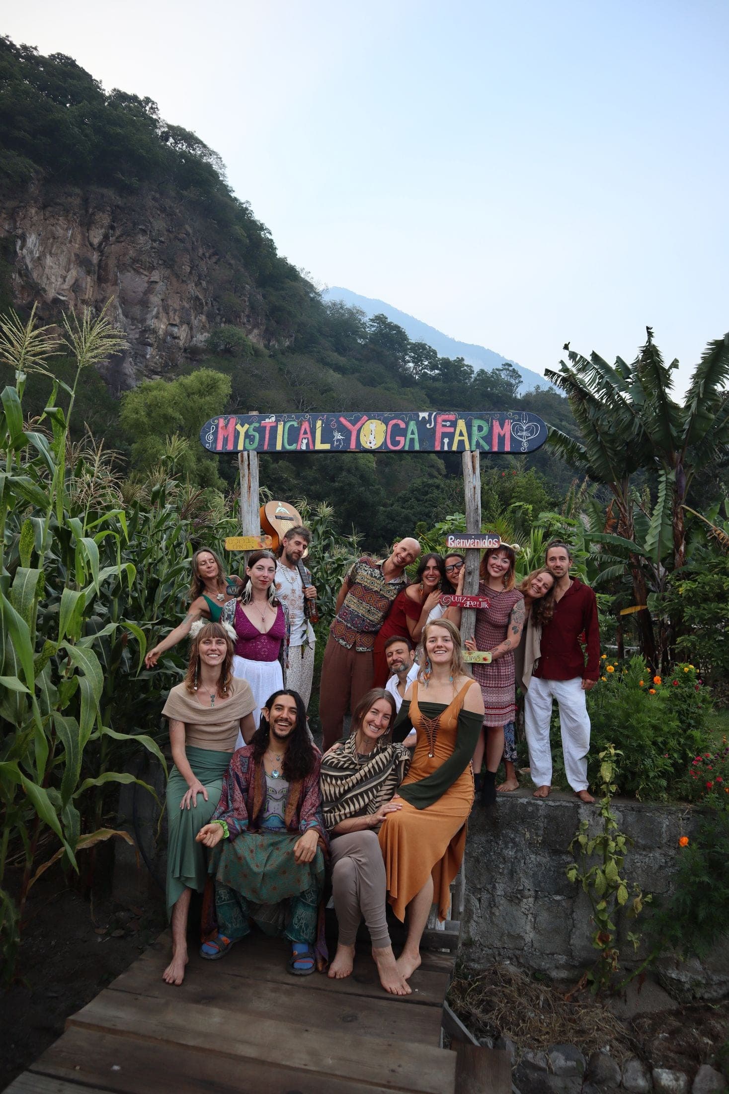 Community gathered under the Mystical Yoga Farm welcome sign