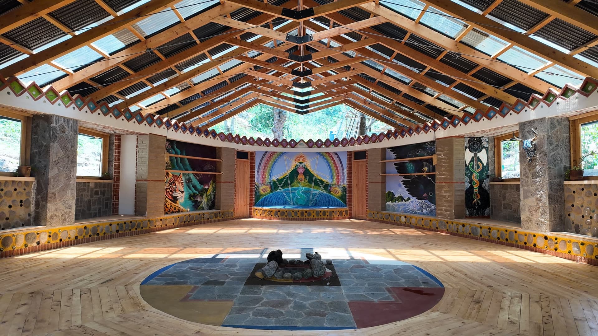Inside Temple da Jiboia — circular hall, fire pit, and murals